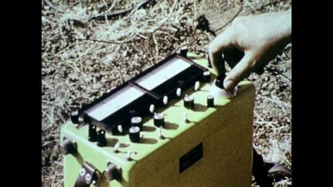 1970s: Man turns dial on machine. Men drill into ground for core sample. Man Stock Footage 86810544