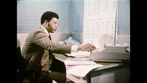 1970s – Man uses adding machine. Skyscrapers. Stock Footage 74679496
