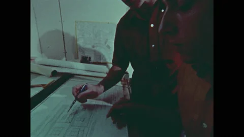 1970s: Men stand at drafting table, look at blueprints. Man talks. Stock Footage 141876113