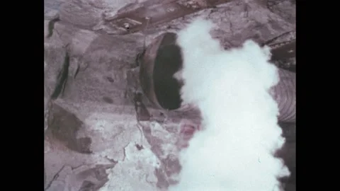 1970s: A miner operates a drill while feeling the cool breeze from an air tube, Stock Footage 236926950