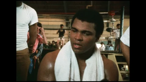1970s: Muhammed Ali talks with interviewer outside boxing ring after match. Stock Footage 112428341