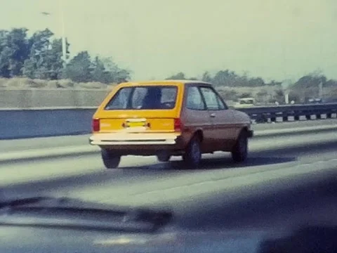 1970's Orange Hatchback Car on the Freeway Video stock 333842504