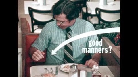 1970s: paper wrapper of straw flies next to man eating at restaurant, "good Stock Footage 303598554