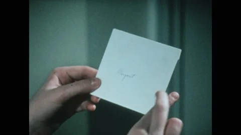1970s: Pen writes on lined paper. Girl holds envelope. Envelope is opened. Stock Footage 219817810