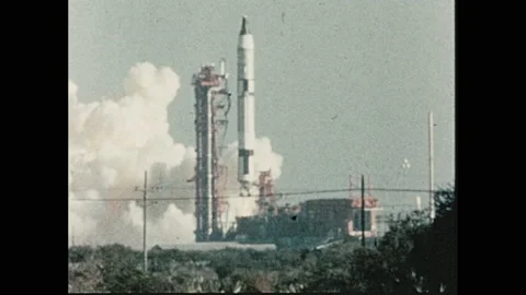 1970s: Person adjusts knobs in computer, server room. Rocket launches into sky. 스톡 동영상 139499319