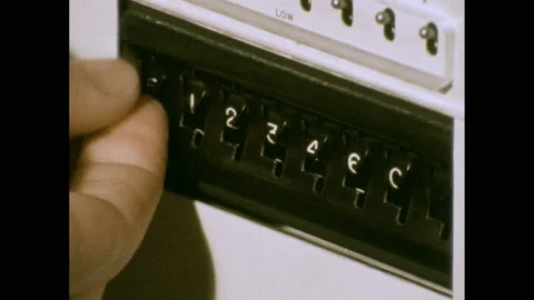1970s: Person adjusts numbers on machine. Buttons on machine. Typewriter types Stock Footage 140118583