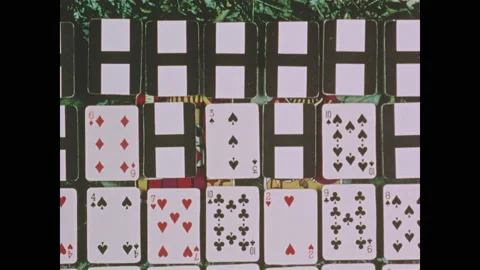 1970s: Playing cards stack up in front of king and queen. King holds hypodermic 스톡 동영상 152990511