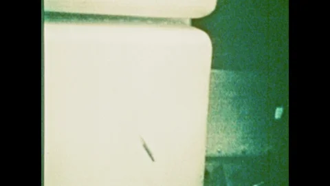 1970s: Small, flat rectangle object floats in zero gravity on Skylab space Stock Footage 125223814