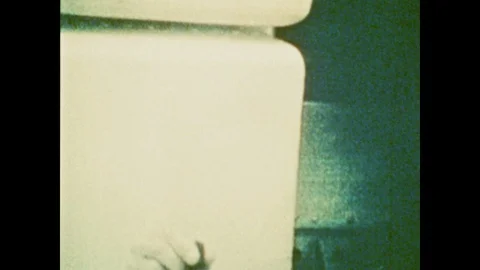 1970s: Small, flat rectangle object floats in zero gravity on Skylab space Stock Footage 125223870