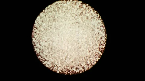 1970s: Sphere lights up.  Animation of objects colliding with sphere.  Stock Footage 86808937