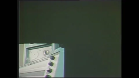1970s: Split screen images of printer moving, tape reel, text on computer Stock Footage