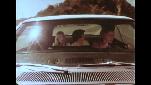 1970s - Teens speed in car down mountain road. Girl attempts to remove keys from Vidéo 74682083