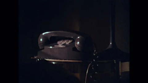 1970s: Telephone on table in dark room. ... | Stock Video | Pond5