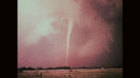 1970s: Thin tornado in distance. Thin tornado on horizon. Stock Footage 121588120