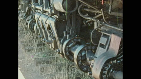 1970s: Train operator starts train. Train rolls down tracks. Boy sits in Stock Footage 147401475