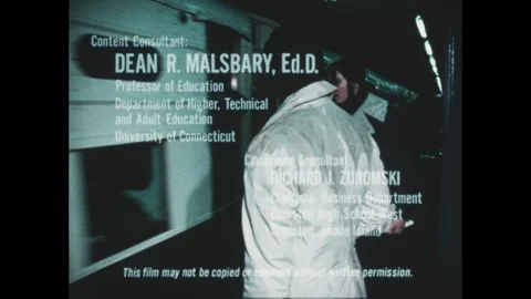 1970s: Train pulls into station. People board. Man sits, writes on lap. Office, Vidéo 252861033