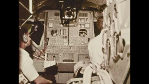 1970s: two astronauts sitting inside the lunar lander module learning how it 库存影片 109221645