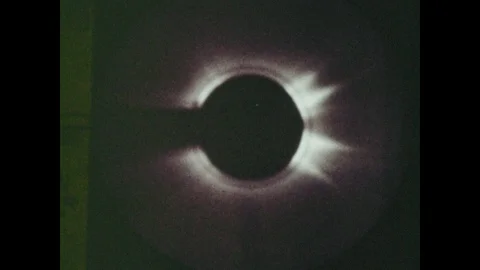 1970s: UNITED STATES: artificial eclipse of sun. Photographs of corona on sun. Stock Footage 116986345