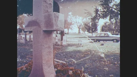 1970s: United States: Car Arrives At Cemetary. Man Gets Out From Car. Man Walks Stock Footage
