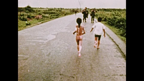 1970s: UNITED STATES: Girl drinks water. Napalm Girl in Vietnam. Rocket takes Stock Footage