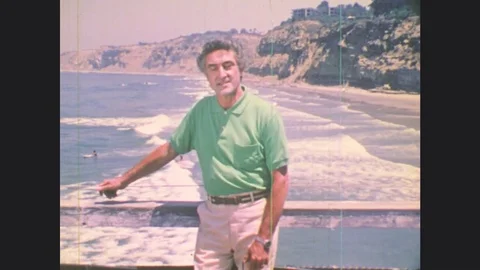 1970s: UNITED STATES: man presents to camera from beach. Ice in sea. Icebreaker Stock Footage