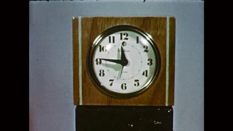 1970s: UNITED STATES: speeding hands on clock face. Man speaks to camera. Stock Footage