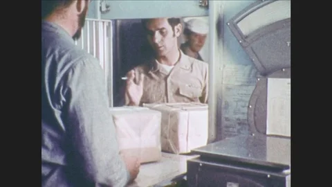 1970s: UNITED STATES: workers process mail. Man works in office. Man sorts Stock Footage 80059530