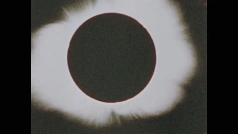 1970s: View of solar eclipse. View of universe. Man speaks. Aerial view of Stockbeeldmateriaal 154226480