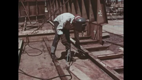1970s: Welders work.  Construction site.  Dials turn. Stock Footage 243366076