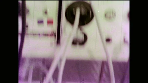 1970s: Wires and knobs on lab equipment. Scientist reads paper graph and 스톡 동영상 90349083