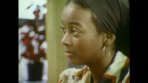 1970s: Woman speaks. Man speaks. Sign: Schwinn Bicycles Supreme Cycle. Man walks Stock Footage