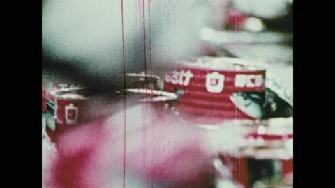 1970s: workers on assembly line inspect &amp; process cans of fish, workers standing Stock Footage 145879651