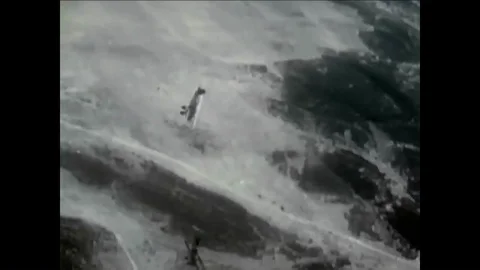 1971-Clark Gable and Wallace Beery talk amongst a group of pilots in the film, Stock Footage 86037174