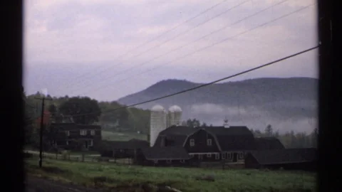 1971: A Functional Farm Plantation Beneath a Row of Hills New Hampshire Video stock 73754082