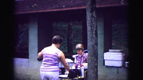 1971: mother daughter cooking food wrapping hotdogs picnic eats OMAHA, NEBRASKA Stock Footage