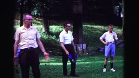 1971: Older Man Throws Lawn Darts With Friends At Park Omaha, Nebraska Stock Footage 68054075