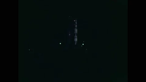 1971 - Vehicles are driven past the Apollo 14 spacecraft at night, where it is Vídeos de archivo 232848879