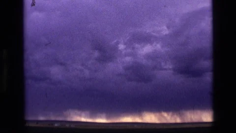 1972: Clouds Gather, Threatening to Form a Tornado as Two People Watch Idaho Stock Footage 70640040