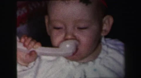 1972: cute chubby baby boy eating breakfast spoon LYNBROOK, NEW YORK Stock Footage