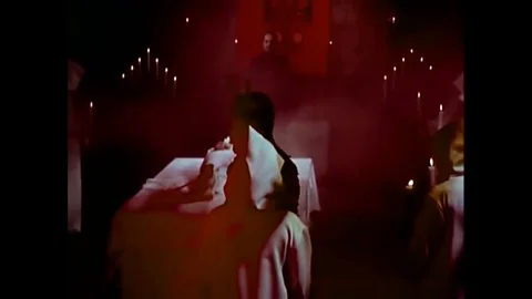 1972 - The devil looks over a screaming virgin sacrifice presented by a doctor Stock Footage 129450360