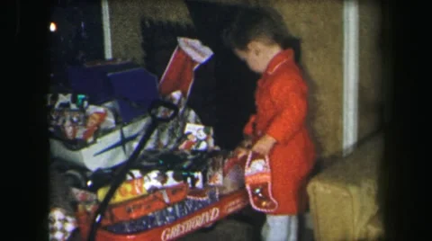 1972: good kids having fun on christmas playing with toys opening LYNBROOK Stock Footage