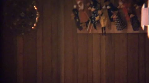 1972: Hand Puppet Collection Hung in Wood Paneled Room Stock Footage 61088442