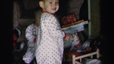 1972: mother and twin babies playing with new christmas toys LYNBROOK, NEW YORK Stock Footage