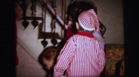 1972: mother sons hanging xmas stocks on staircase LYNBROOK, NEW YORK Stock Footage