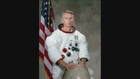 1972 - A portrait of astronaut Eugene Andrew Cernan in a spacesuit with a globe Stock Footage 82334645