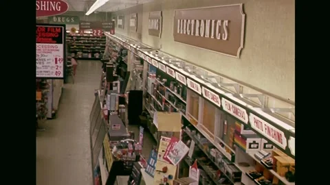 1972 supermarkets - racks with electronics in the store Stock Footage 234912584