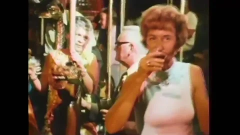 1973 - Drunk people ride a carousel in search of the next high. Stock Footage 241798521