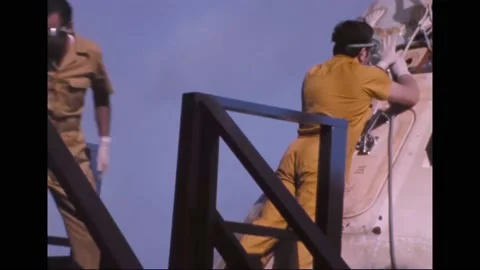 1973 - Engineers aboard the USS Ticonderoga work on opening up the Skylab 2 Stock Footage 232846775