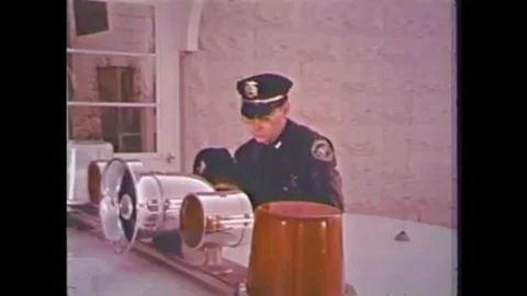 1974 - A drunk driver in custody takes a breath test at a police station. Stock Footage 115372066