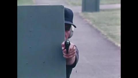 1974 - An instructor teaches basic shooting techniques, including firing a Video stock 79433741
